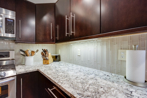 Cambria Bellingham Countertop with Stainless Steel Appliance , Kona Finished Maple Cabinets and Glass Brick Mosaic Tiles